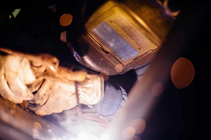 Person wearing black welding helmet